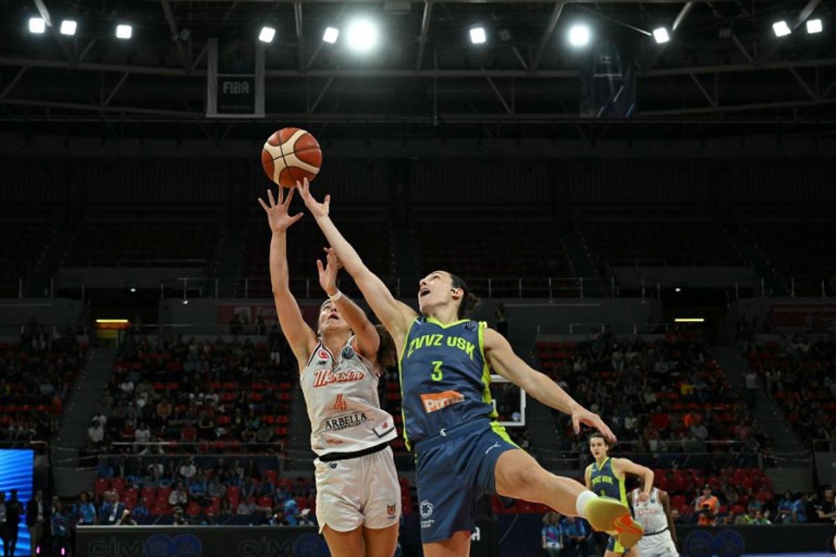 CBK Mersin's French pointguard #04 Marine Fauthoux and Prague's Slovak shooting guard #03 Teja Oblak reach for the ball during the Euroleague Women's final basketball match between CIMSA CBK Mersin and ZVVZ USK Prague at the Pabellon Principe Felipe arena in Zaragoza on April 13, 2025.  JAVIER SORIANO / AFP