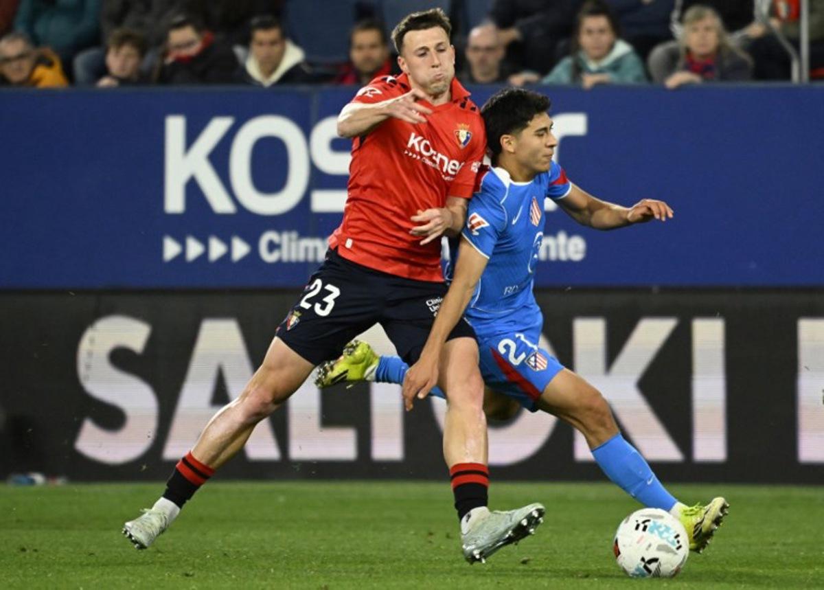 Osasuna's Spanish defender #23 Abel Bretones fights for the ball with Atletico Madrid's US midfielder #21 Obed Vargas during the Spanish league football match between CA Osasuna and Club Atletico de Madrid at El Sadar Stadium in Pamplona on May 12, 2026.  ANDER GILLENEA / AFP