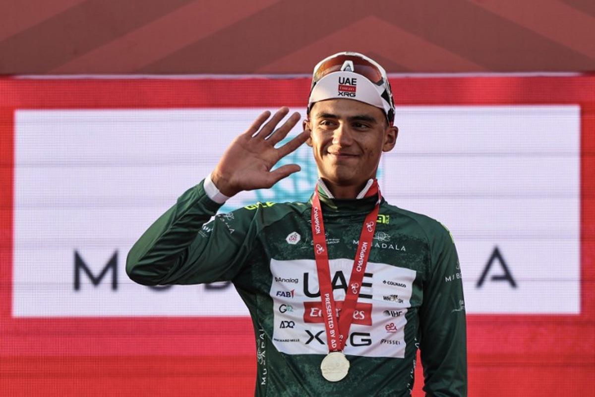 UAE Team Emirates's Mexican rider Isaac Del Toro Romero wears the green jersey as he celebrates on the podium at the end of the third stage of the UAE Tour cycling event from Umm al-Quwain to Jebel Mobrah in Ras al-Khaimah on February 18, 2026.  Fadel SENNA / AFP