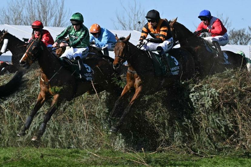 Jockey Patrick Mullins (2R) jumps The Chair on Nick Rockett on the first circuit on the way to winning the Grand National Handicap Chase on the final day of the Grand National Festival horse race meeting at Aintree Racecourse in Liverpool, north-west England, on April 5, 2025.  Paul ELLIS / AFP