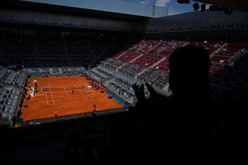 A spectator applauds during the 2021 WTA Tour Madrid Open tennis tournament singles match between Belgium's Elise Mertens and Romania's Simona Halep at the Caja Magica in Madrid on May 4, 2021.  GABRIEL BOUYS / AFP