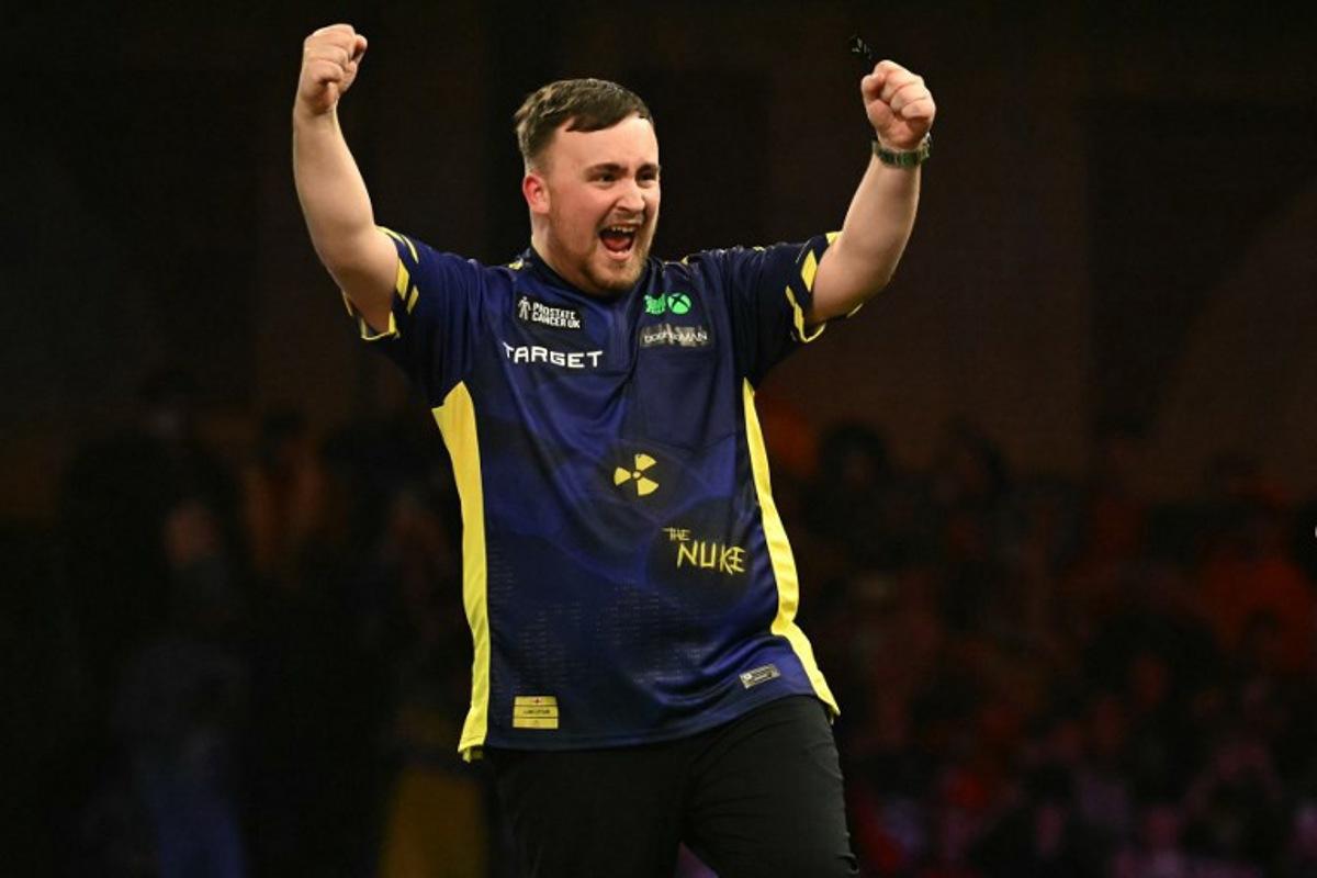 England's Luke Littler celebrates his win over Netherlands' Michael van Gerwen in the PDC World Darts Championship final, at Alexandra Palace in London on January 3, 2025. Luke Littler became darts' youngest world champion at just 17 after thrashing three-time winner Michael van Gerwen in front of an adoring home crowd at London's Alexandra Palace on Friday. This time there was no stopping "Luke the Nuke" as he stormed past Dutchman Van Gerwen by seven sets to three. Ben STANSALL / AFP