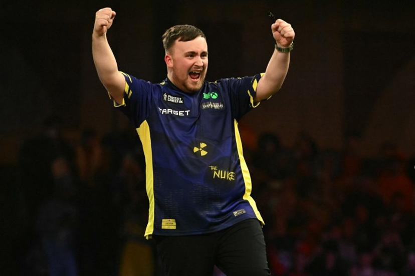England's Luke Littler celebrates his win over Netherlands' Michael van Gerwen in the PDC World Darts Championship final, at Alexandra Palace in London on January 3, 2025. Luke Littler became darts' youngest world champion at just 17 after thrashing three-time winner Michael van Gerwen in front of an adoring home crowd at London's Alexandra Palace on Friday. This time there was no stopping "Luke the Nuke" as he stormed past Dutchman Van Gerwen by seven sets to three. Ben STANSALL / AFP