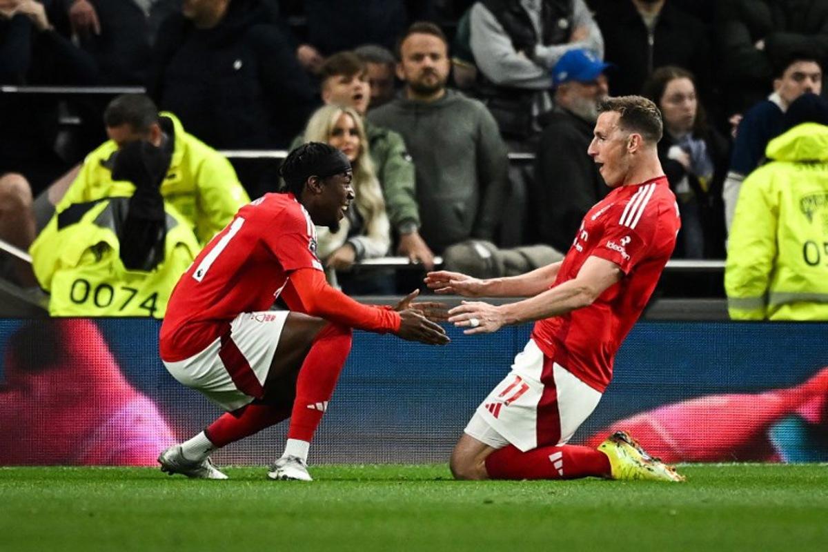 Nottingham Forest's New Zealand striker #11 Chris Wood (R) celebrates after scoring his team second goal during the English Premier League football match between Tottenham Hotspur and Nottingham Forest at the Tottenham Hotspur Stadium in London, on April 21, 2025.  Ben STANSALL / AFP
