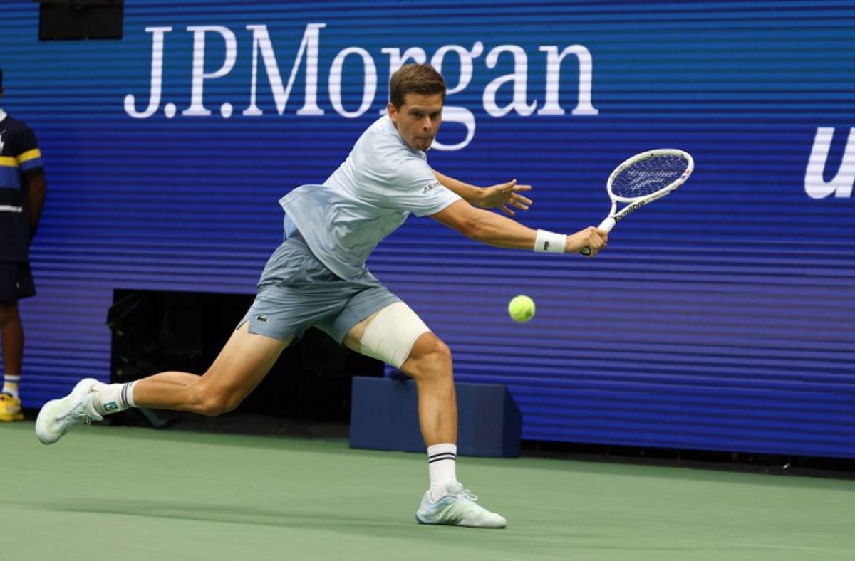 Belgium's Alexander Blockx returns the ball to Russia's Karen Khachanov during the men's singles quarter-final tennis match on day eleven of the US Open tennis tournament at the USTA Billie Jean King National Tennis Center in New York City on September 9, 2026.  TIMOTHY A. CLARY / AFP