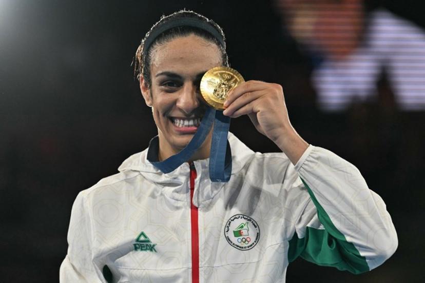 Gold medallist Algeria's Imane Khelif poses on the podium during the medal ceremony for the women's 66kg final boxing category during the Paris 2024 Olympic Games at the Roland-Garros Stadium, in Paris on August 9, 2024.  MOHD RASFAN / AFP