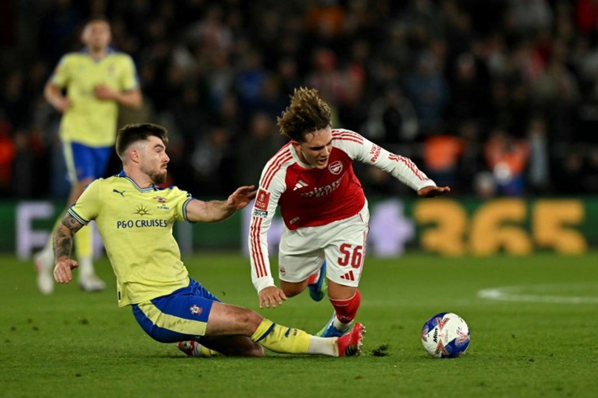 Arsenal's English midfielder #56 Max Dowman is fouled by Southampton's Irish defender #03 Ryan Manning during the English FA Cup quarter final football match between Southampton and Arsenal at St Mary's Stadium in Southampton, southern England on April 4, 2026.  Glyn KIRK / AFP