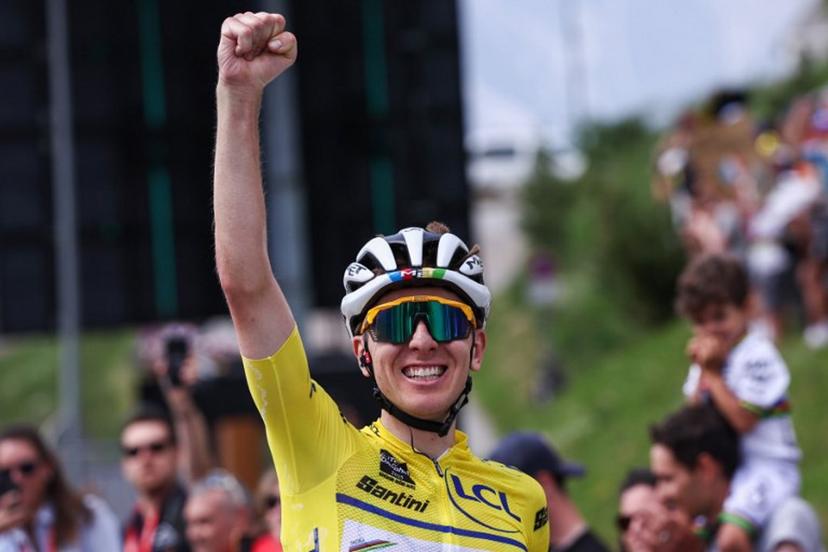 UAE Team Emirates XRG's Slovenian rider Tadej Pogačar wearing the overall leader's yellow jersey celebrates as he crosses the finish line to win the 7th stage of the 77th edition of the Criterium du Dauphine cycling race, 131,6 km between Grand-Aigueblanche and Valmeinier, on June 14, 2025.  Anne-Christine POUJOULAT / AFP