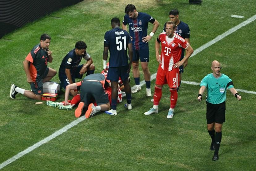 Paris Saint-Germain's players watch Bayern Munich's German midfielder #42 Jamal Musiala injured on the ground during the FIFA Club World Cup 2025 quarterfinal football match between France's Paris Saint-Germain and Germany's Bayern Munich at the Mercedes-Benz Stadium in Atlanta on July 5, 2025.  ROBERTO SCHMIDT / AFP