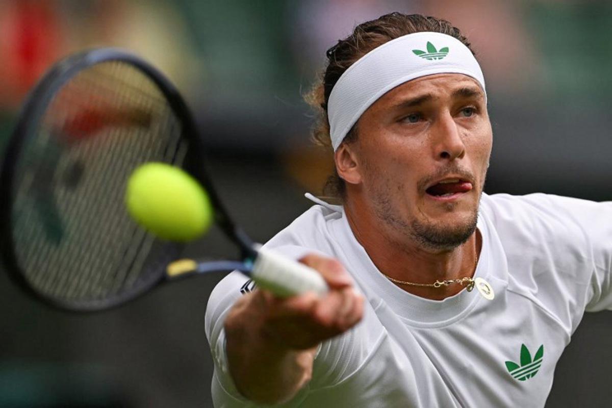 Germany's Alexander Zverev plays a forehand return to France's Arthur Rinderknech during their men's singles first round tennis match on the second day of the 2025 Wimbledon Championships at The All England Lawn Tennis and Croquet Club in Wimbledon, southwest London, on July 1, 2025.  Glyn KIRK / AFP