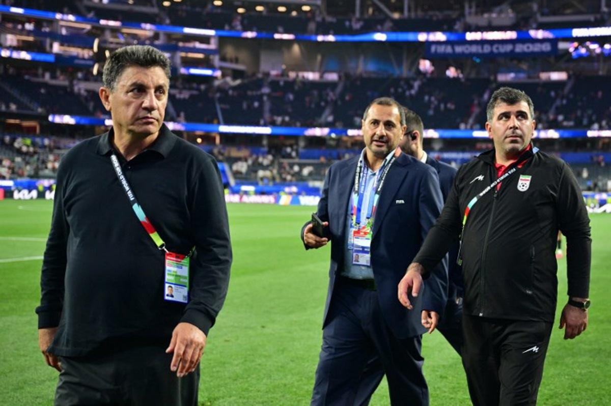 Iran's head coach Amir Ghalenoei (L) walks out the pitch after the 2026 World Cup Group G football match between Iran and New Zealand at Los Angeles Stadium in Inglewood on June 15, 2026.   Frederic J. Brown / AFP