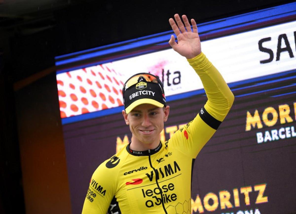 Stage winner Team Visma's British rider James Matthew Brennan celebrates with the yellow jersey on the podium of the first stage of the 2025 Volta a Catalonya cycling tour of Catalonya, a 178,3 km loop starting and finishing in Sant Feliu de Guixols, on March 24, 2025.  Josep LAGO / AFP