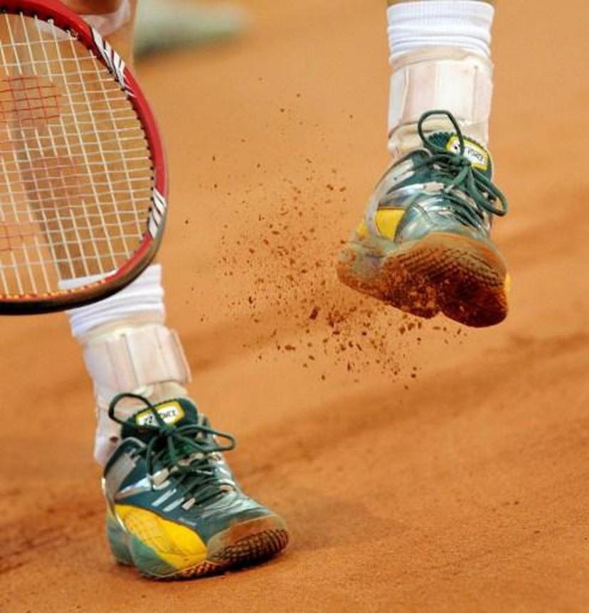 Australia's Lleyton Hewitt hits the clay from his shoe in his match against Yuichi Sugita of Japan during their Davis Cup tennis tie played in Brisbane on May 9, 2010.  Hewitt won the dead rubber 7-5, 6-2 to give Australia an unbeatable 4-0 lead.  RESTRICTED TO EDITORIAL USE  NO ADVERTISING USE  NO PROMOTIONAL USE  NO MERCHANDISING USE  AFP PHOTO/William WEST RESTRICTED TO EDITORIAL USE  NO ADVERTISING USE  NO PROMOTIONAL USE  NO MERCHANDISING USE

