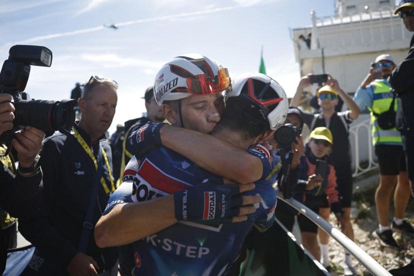 Soudal Quick-Step team's French rider Valentin Paret-Peintre (R) celebrates with teammate Soudal Quick-Step team's Belgian rider Ilan Van Wilder (C) after crossing the finish line to win the 16th stage of the 112th edition of the Tour de France cycling race, 171.5 km between Montpellier and Mont Ventoux, southern France, on July 22, 2025.  MARTIN DIVISEK / POOL / AFP