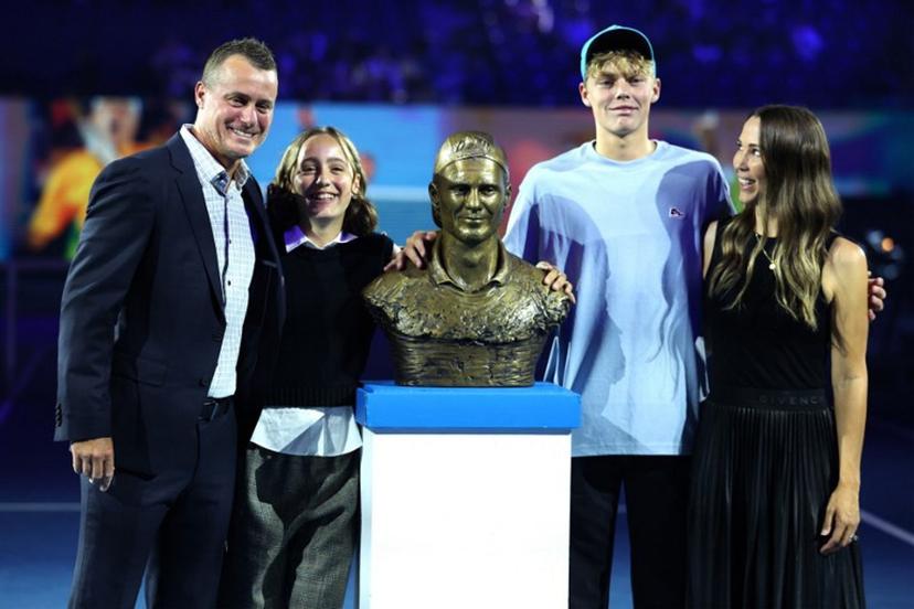 This picture taken on January 24, 2024 shows former Australian tennis player Lleyton Hewitt with his wife Bec Hewitt (R) and children Ava Hewitt, Cruz Hewitt posing with a statue of himself as he is inducted into the Australian Tennis Hall of Fame on Rod Laver Arena during the Australian Open tennis tournament in Melbourne.   Martin KEEP / AFP