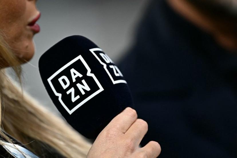 A presenter of sports streaming service DAZN holds a microphone during the Italian Serie A football match between Juventus and Cagliari, at The Allianz Stadium, in Turin on November 11, 2023.  GABRIEL BOUYS / AFP
