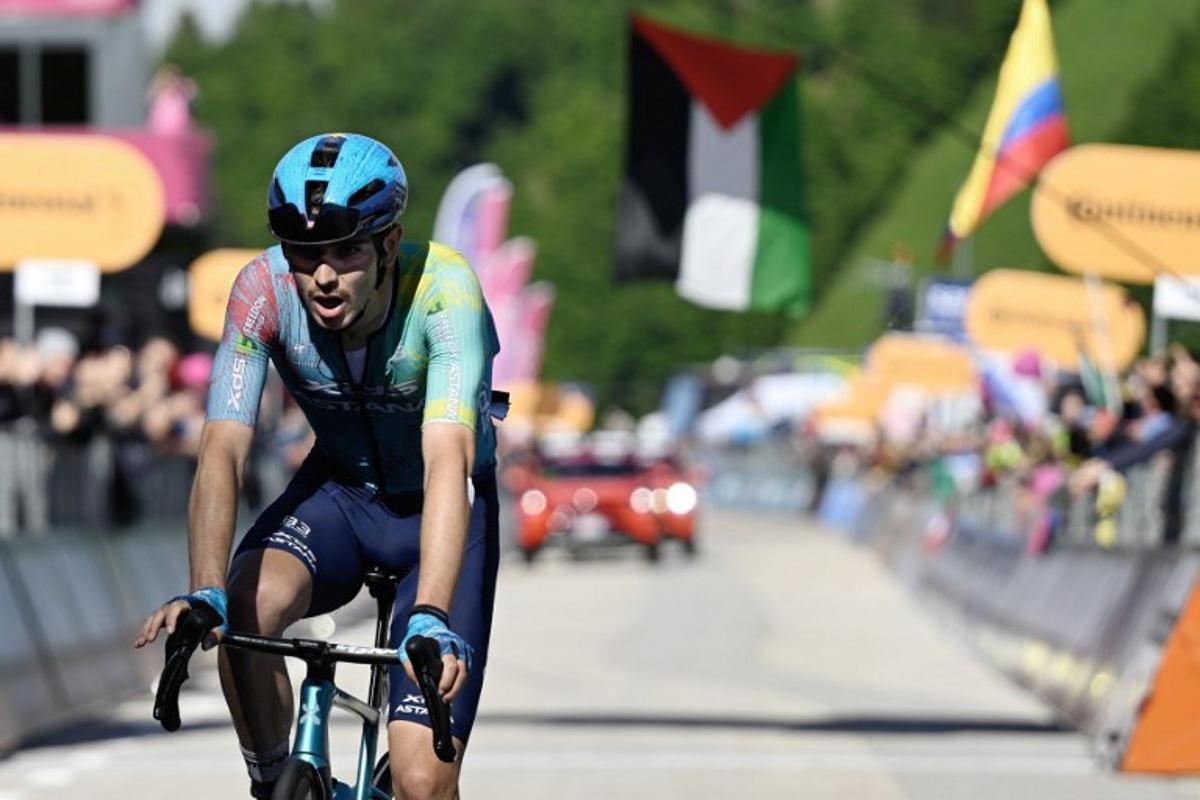 XDS Astana Team's Italian rider Christian Scaroni celebrates after victory as he crosses the finish line of the 16th stage of the 108th Giro d'Italia cycling race of 203kms from Piazzola sul Brenta to San Valentino on May 27, 2025.  Ivan Benedetto / AFP