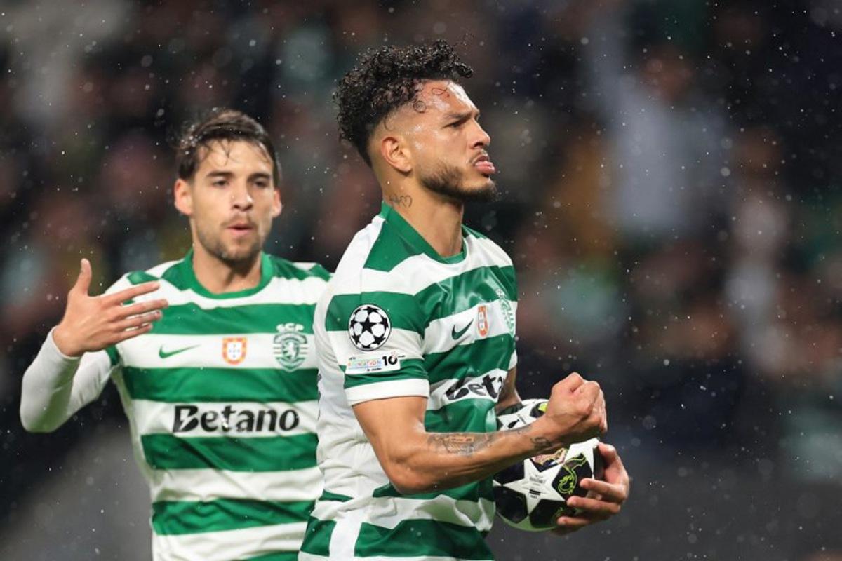 Sporting Lisbon's Colombian forward #97 Luis Suarez (R) celebrates scoring his team's third goal with Sporting Lisbon's Portuguese midfielder #23 Daniel Braganca during the UEFA Champions League last 16 second leg football match between Sporting CP and Bodoe/Glimt at Jose Alvalade stadium in Lisbon on March 17, 2026.  PATRICIA DE MELO MOREIRA / AFP