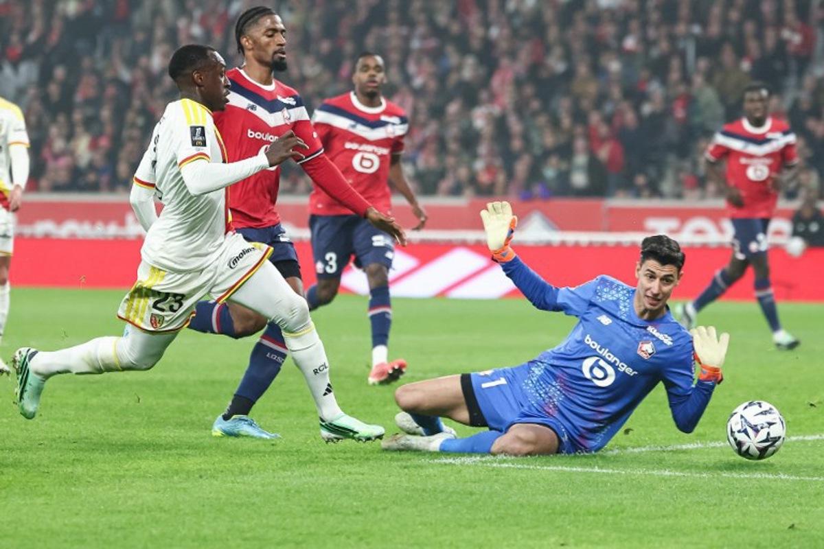 Lens' Saudi Arabian defender #23 Saud Abdulhamid (L) attempts to score in front of Lille's Turkish goalkeeper #01 Berke Ozer during the French L1 football match between Lille LOSC and RC Lens at the Stade Pierre-Mauroy in Villeneuve-d'Ascq, northern France, on October 30, 2026.  Sameer Al-DOUMY / AFP