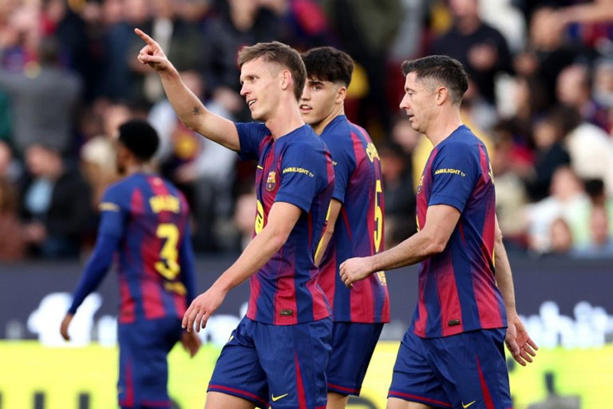 Barcelona's Spanish midfielder #20 Daniel Olmo (L) celebrates scoring his team's second goal during the Spanish League football match between FC Barcelona and Deportivo Alaves at Camp Nou Stadium in Barcelona on November 29, 2025.  Josep LAGO / AFP