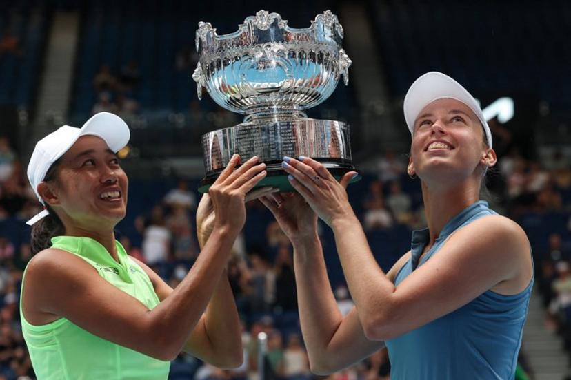 Belgium's Elise Mertens (R) and partner China's Zhang Shuai hold their trophy after winning their women's doubles final match against Kazakhstan's Anna Danilina and Serbia's Aleksandra Krunic on day fourteen of the Australian Open tennis tournament in Melbourne on January 31, 2026.  DAVID GRAY / AFP