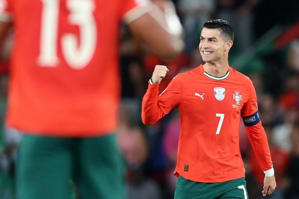 Portugal's forward #16 Cristiano Ronaldo celebrates after scoring the equalising goal during the 2026 World Cup qualifiers Europe zone group F football match between Portugal and Hungary at Jose Alvalade stadium in Lisbon on October 14, 2025.  PATRICIA DE MELO MOREIRA / AFP