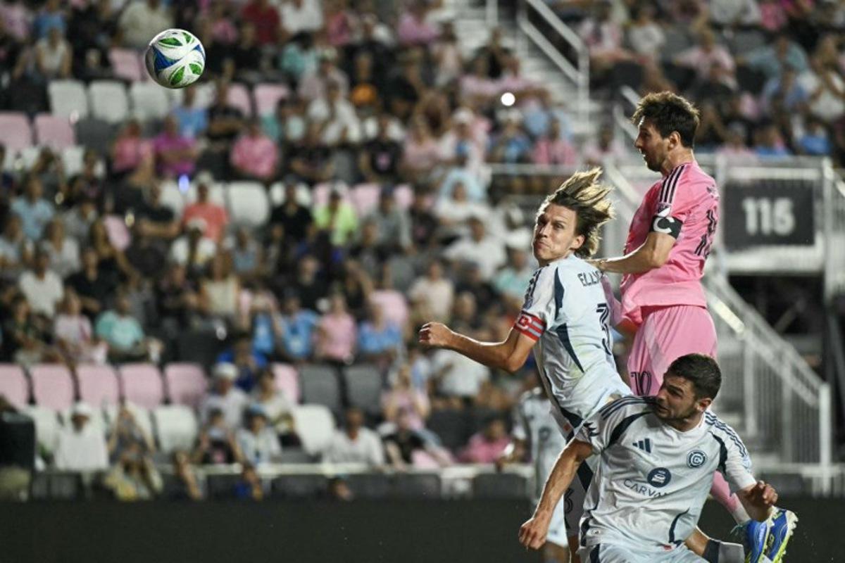 Inter Miami's Argentine forward #10 Lionel Messi (R) heads the ball over Chicago's English defender #03 Jack Elliott and Belgian forward #09 Hugo Cuypers during the Major League Soccer (MLS) regular season football match between Inter Miami CF and Chicago Fire FC at Chase Stadium in Fort Lauderdale, Florida, on September 30, 2025.  CHANDAN KHANNA / AFP