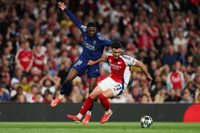 Paris Saint-Germain's French forward #10 Ousmane Dembele (L) fights for the ball with Arsenal's Spanish midfielder #23 Mikel Merino during the UEFA Champions League Semi-final First Leg football match between Arsenal and Paris Saint-Germain (PSG) at the Emirates Stadium in north London, on April 29, 2025.  Adrian Dennis / AFP
