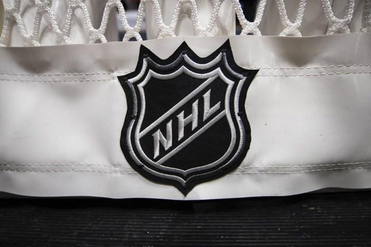 (FILES) In this file photo taken on October 16, 2019 a detailed view of the NHL logo taken on the back of the goal netting is seen before the game between the Washington Capitals and the Toronto Maple Leafs at Capital One Arena in Washington, DC.  Nine more games were postponed on December 31, 2021 by the National Hockey League over Covid-19 issues, these following new attendance restrictions in Canadian cities due to the deadly virus. Scott TAETSCH / GETTY IMAGES NORTH AMERICA / AFP