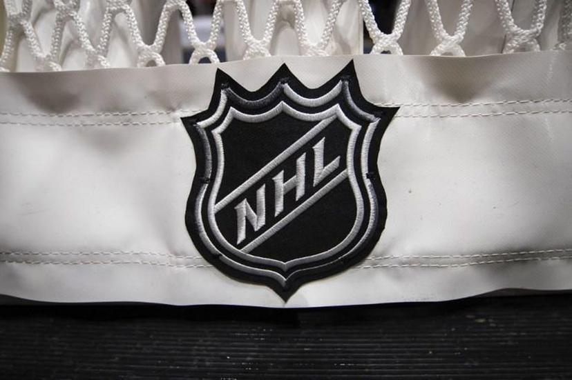 (FILES) In this file photo taken on October 16, 2019 a detailed view of the NHL logo taken on the back of the goal netting is seen before the game between the Washington Capitals and the Toronto Maple Leafs at Capital One Arena in Washington, DC.  Nine more games were postponed on December 31, 2021 by the National Hockey League over Covid-19 issues, these following new attendance restrictions in Canadian cities due to the deadly virus. Scott TAETSCH / GETTY IMAGES NORTH AMERICA / AFP