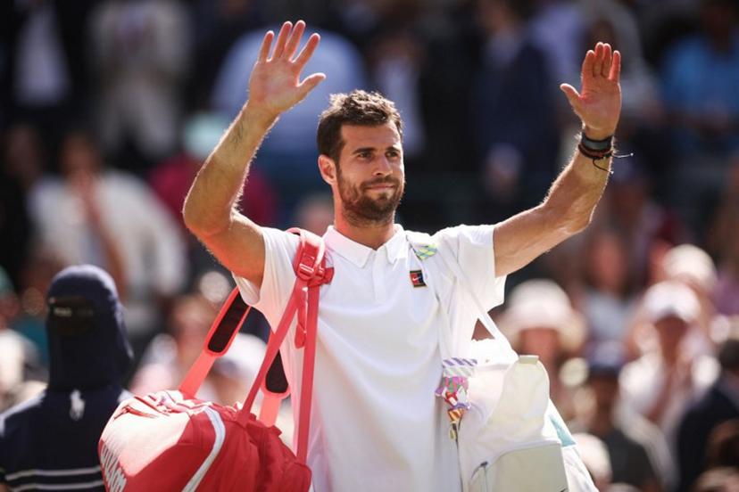 Russia's Karen Khachanov waves to the crowd as he leaves the court after losing against US player Taylor Fritz at the end of their men's singles quarter-final tennis match on the ninth day of the 2025 Wimbledon Championships at The All England Lawn Tennis and Croquet Club in Wimbledon, southwest London, on July 8, 2025.  HENRY NICHOLLS / AFP