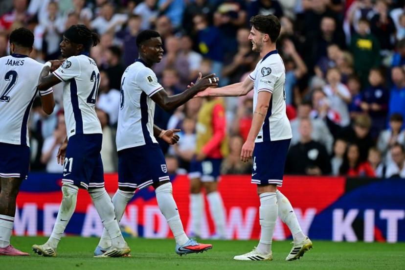 England's midfielder Declan Rice (R) celebrates scoring the team's second goal during the 2026 World Cup Group K qualifier football match between England and Andorra, at Villa Park, in Birmingham, on September 6, 2025.   Ben STANSALL / AFP