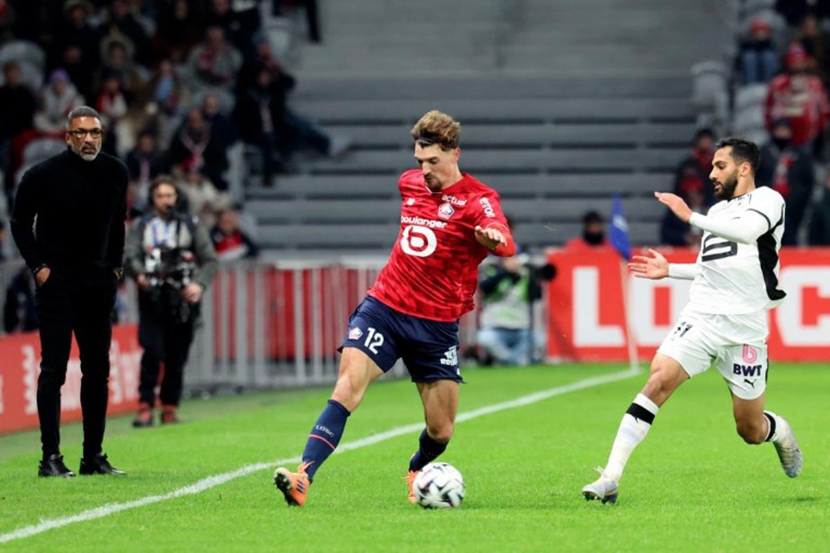 Lille's Belgian defender #12 Thomas Meunier (L) and Rennes' Jordanian forward #11 Mousa Tamari fight for the ball during the French L1 football match between Lille LOSC and Stade Rennais FC at the Stade Pierre-Mauroy in Villeneuve-d'Ascq, northern France, on January 3, 2026.  Francois LO PRESTI / AFP