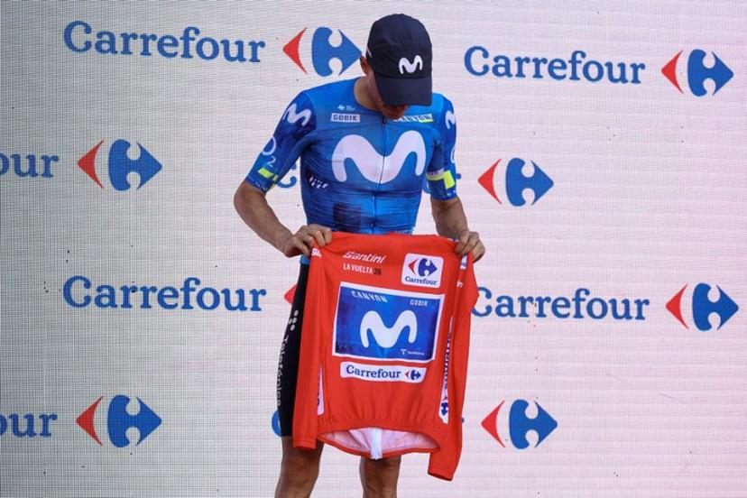 New overall race leader Team Movistar's Spanish rider Enric Mas holds the race leader's red jerse without wearing it on the podium after the eighth stage of the Vuelta a Espana 2026, a 171 km race between Pucol and Xeraco on August 29, 2026.   Previous race leader Tadej Pogacar pulled out of the Vuelta a Espana on Saturday after a heavy fall 31km from the finish of a flat stage eight left him with shoulder and face injuries. Pogacar of Team UAE has won five Tour de France titles and a Giro d'Italia and was targetig his first overall victory on the Spanish 21-day race. Josep LAGO / AFP