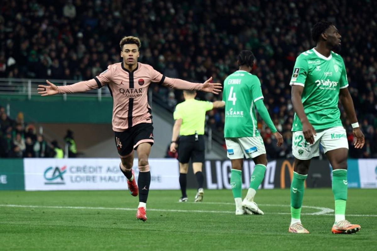 Paris Saint-Germain's French midfielder #14 Desire Doue celebrates scoring his team's third goal during the French L1 football match between AS Saint-Etienne and Paris Saint-Germain (PSG) at the Geoffroy-Guichard stadium in Saint-Etienne, central France on March 29, 2025.  Alex MARTIN / AFP