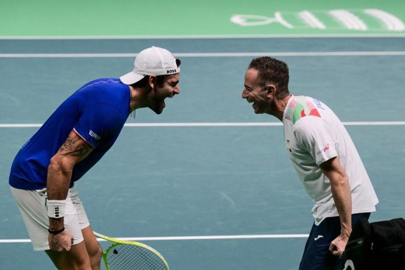 Italy's Matteo Berrettini (L) celebrates with Italy's coach Filippo Volandri after winning against Austria's Jurij Rodionov during their Davis Cup men's singles quarter finals tennis match, at the Super Tennis Arena, in Bologna, northen Italy, on November 19, 2025.  Tiziana FABI / AFP