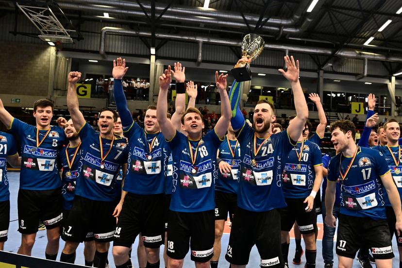 Bocholt's Serge Spooren, Bocholt's Thomas Driesen and Bocholt's Tim Claessens celebrate after winning a game between Achilles Bocholt and Sporting Pelt, the men's final of the Belgian handball cup, Saturday 01 April 2023, in Hasselt. BELGA PHOTO JOHAN EYCKENS