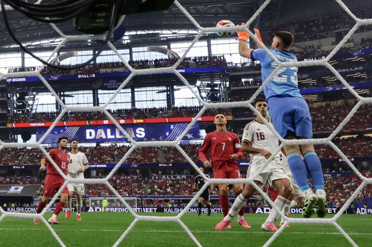 Spain's goalkeeper #23 Unai Simon grabs the ball past Portugal's forward #07 Cristiano Ronaldo during the 2026 World Cup round of 16 football match between Portugal and Spain at the Dallas Stadium in Arlington on July 6, 2026.  Aric Becker / AFP