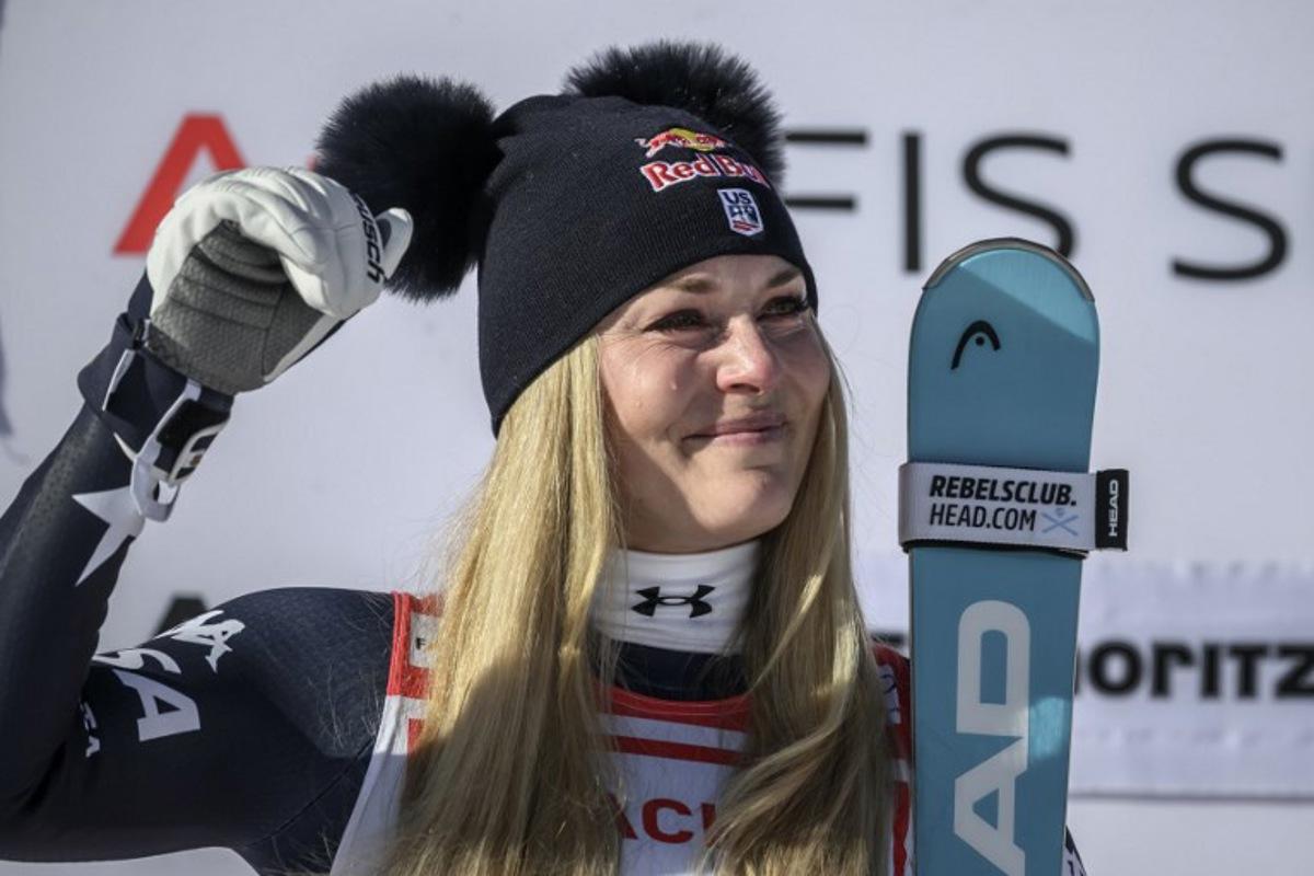 First-placed US Lindsey Vonn cries on the podium as she celebrates after competing in the women's downhill race during the FIS Alpine Ski World Cup 2025-2026, in St Moritz, south-eastern Switzerland on December 12, 2025.  Fabrice COFFRINI / AFP