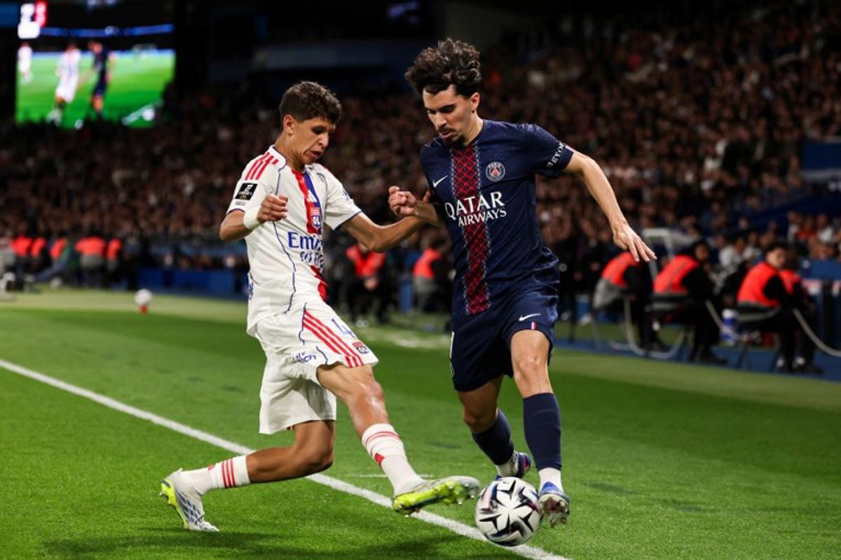 Lyon's French midfielder #44 Khalis Merah (L) fights for the ball with Paris Saint-Germain's Portuguese midfielder #17 Vitinha (R) during the French L1 football match between Paris Saint-Germain (PSG) and Olympique Lyonnais (OL) at the Parc des Princes stadium in Paris on April 19, 2026.  FRANCK FIFE / AFP