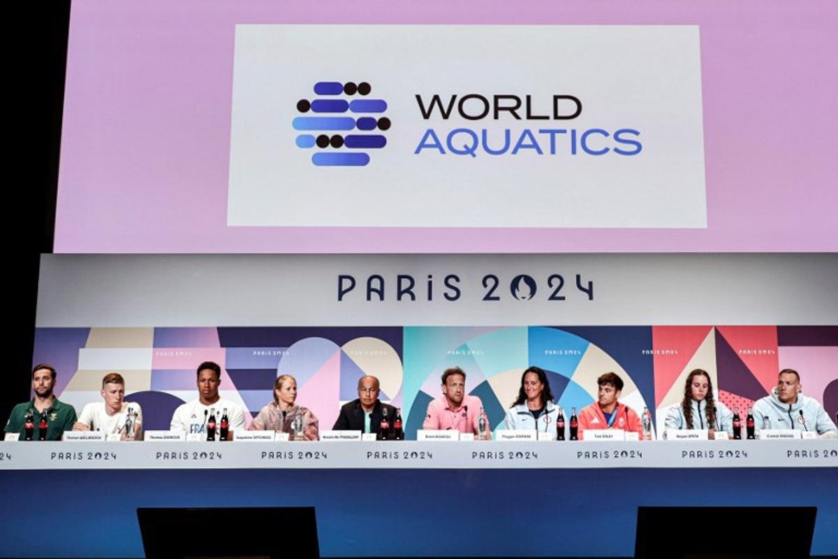 (L to R) South Africa's swimmer Chad Le Clos, Germany's swimmer Florian Wellbrock, France's water polo player Thomas Vernoux, Canada's swimmer Jacqueline Simoneau, World Aquatics President Husain al-Musallam and Executive Director Brent Novicki, US' water polo player Maggie Steffens, Britain's Diver Tom Daley, and US' swimmers Regan Smith and Caeleb Dressel attend the World Aquatics Olympic press conference ahead of the Paris 2024 Olympic Games in Paris, on July 25, 2024.  STEPHANE DE SAKUTIN / AFP