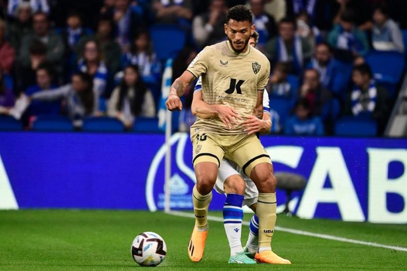Almeria's Colombian forward Luis Suarez (Front) fights for the ball with Real Sociedad's Spanish defender Aihen Munoz during the Spanish league football match between Real Sociedad and UD Almeria at the Reale Arena stadium in San Sebastian on May 23, 2023.  ANDER GILLENEA / AFP
