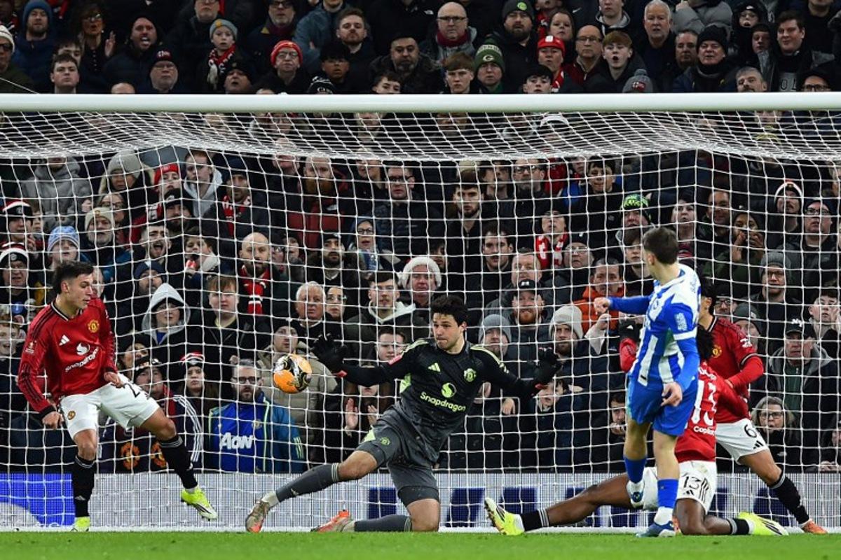 Brighton's German midfielder #08 Brajan Gruda (R) scores the opening goal during the English FA Cup third round football match between Manchester United and Brighton and Hove Albion at Old Trafford Stadium in Manchester, north west England, on January 11, 2026.  PETER POWELL / AFP