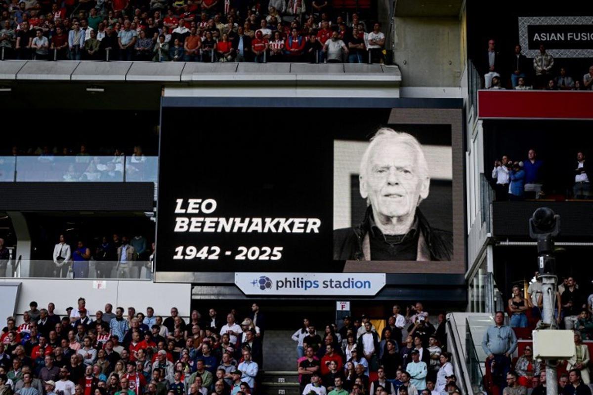 Fans observe a minute of silence for the late Dutch football player and coach Leo Beenhakker ahead of the Dutch Eredivisie fooball match between PSV Eindhoven and Almere City FC at the Phillips Stadium in Eindhoven on April 12, 2025.  Olaf Kraak / ANP / AFP