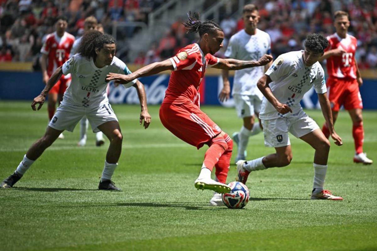Bayern Munich's French midfielder #17 Michael Olise (C) fights for the ball with Auckland City's New Zealander midfielder #10 Dylan Manickum (L) and Auckland City's New Zealander defender #13 Nathan Lobo during the Club World Cup 2025 Group C football match between Germany's Bayern Munich and New Zealand's Auckland City at the TQL stadium in Cincinnati on June 15, 2025.  Paul ELLIS / AFP