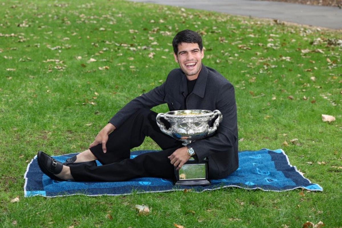 Spain's Carlos Alcaraz poses with the Norman Brookes Challenge Cup at the Royal Exhibition Building following his victory against Serbia's Novak Djokovic in the men's singles final match of the Australian Open tennis tournament in Melbourne on February 2, 2026.  David GRAY / AFP