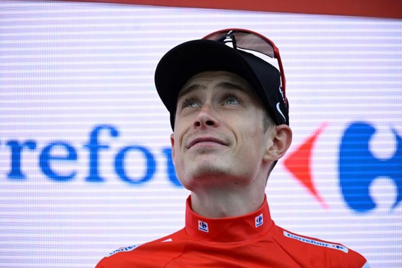 Overall race leader red jersey holder team Visma-Lease a bike's Danish rider Jonas Vingegaard celebrates on the podium of the 19th stage of the Vuelta a Espana, a 159 km race between Rueda and Guijuelo, on September 12, 2025.    Miguel RIOPA / AFP