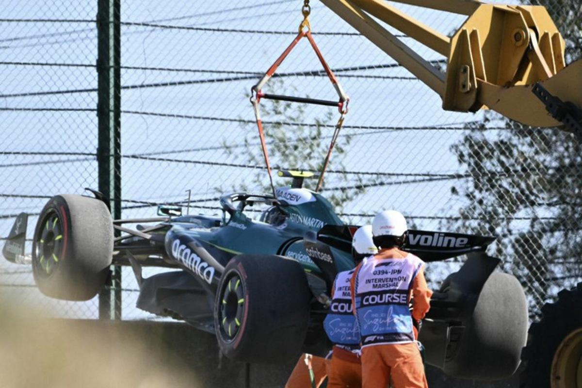 Marshals remove the car of Aston Martin's Spanish driver Fernando Alonso after hitting the gravel during the second practice session of the Formula One Japanese Grand Prix at the Suzuka circuit in Suzuka, Mie prefecture on April 4, 2025.  Philip FONG / AFP
