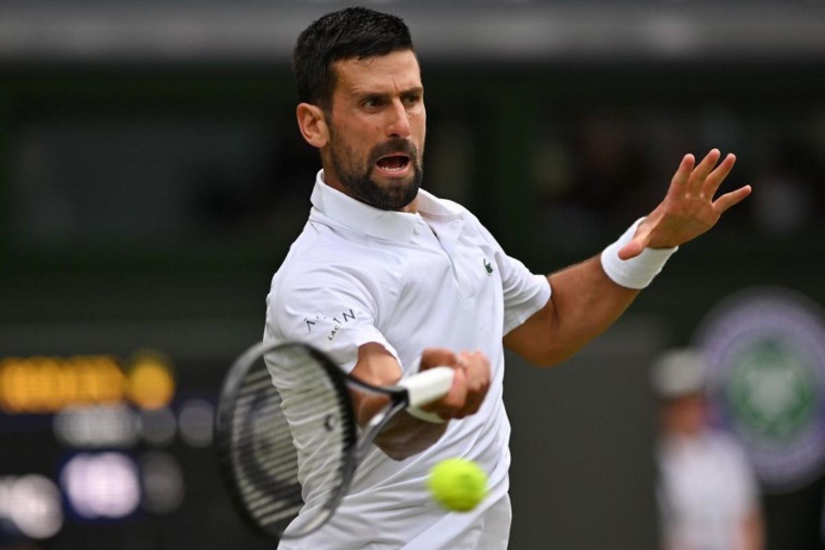 Serbia's Novak Djokovic plays a forehand return to Serbia's Miomir Kecmanovic during their men's singles third round tennis match on the sixth day of the 2025 Wimbledon Championships at The All England Lawn Tennis and Croquet Club in Wimbledon, southwest London, on July 5, 2025.  Glyn KIRK / AFP