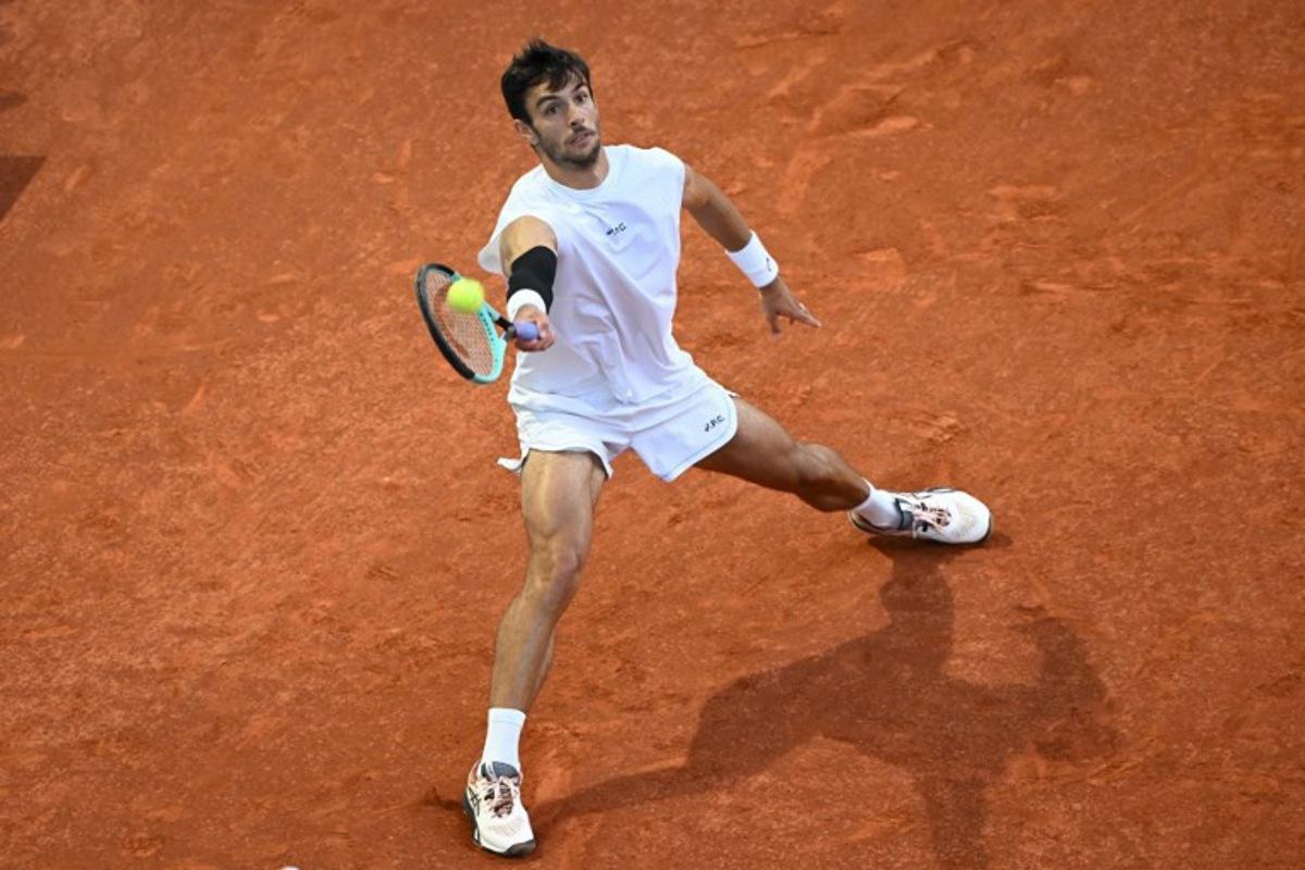 Italy's Lorenzo Musetti returns a forehand to Canada's Gabriel Diallo during their 2025 ATP Tour Madrid Open tennis tournament quarter-final singles match at the Caja Magica in Madrid, on May 1, 2025.  JAVIER SORIANO / AFP